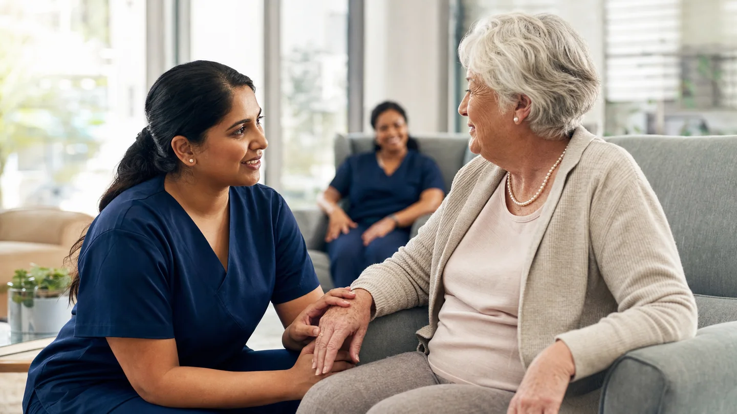 Indian-Australian aged-care nurse speaking with an older Australian resident in a care home